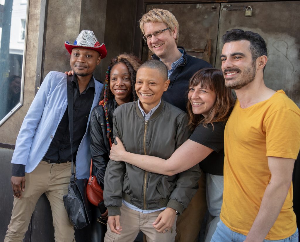 The leads and filmmakers of "Unsettled" Junior Mayema -- in the red, white, and blue cowboy hat -- is a client of the Guardian Group.